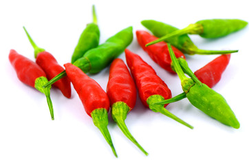 Green and red chili on white background.