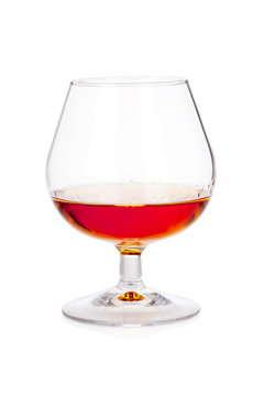 Glass of cognac or scotch on white