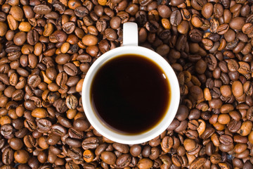 A cup of coffee with coffee bean as background