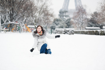 Happy young girl enjoying rare snowy day in Paris