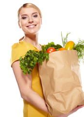 woman holding a bag full of healthy food. shopping .