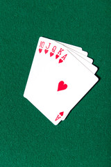 Royal Flush poker card sequence on a green table