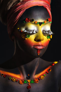 African woman with artistic ethnic makeup on her face and should