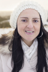 woman laughing in snow covered fields at sunset
