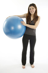 Young woman holding blue exercise ball