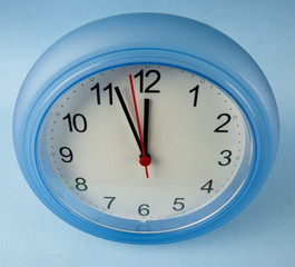 Clock midnight or noon on blue background
