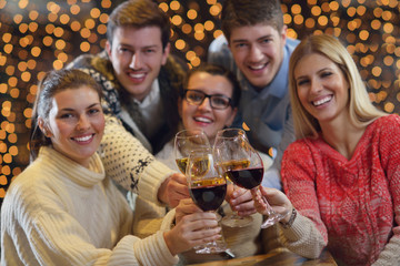 Group of happy young people drink wine at party