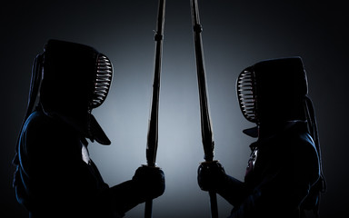 Two kendo fighters opposite each other with shinai