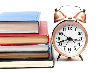 clock and books on a white background