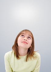 Teen girl looking up to copy space