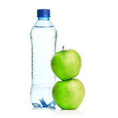Bottle of sparkling water and green apple