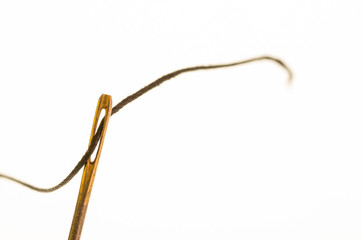 Needle threaded with sewing thread