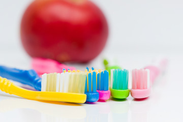 Toothbrushes and apple
