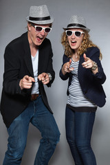 Young couple wearing hat and sunglasses. Man and woman.