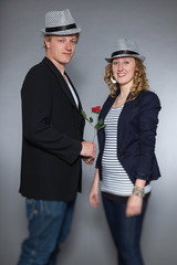 Young couple in love holding red rose. Man and woman.