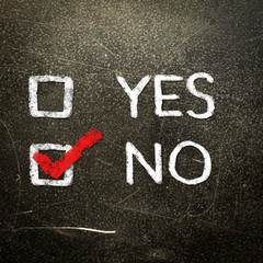 Yes or no written on the blackboard with white chalk. Your choic