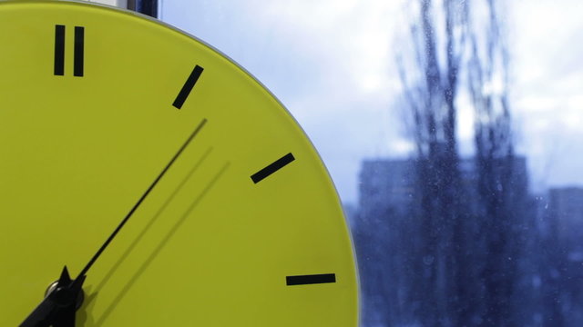 Yellow clock. Time lapse.