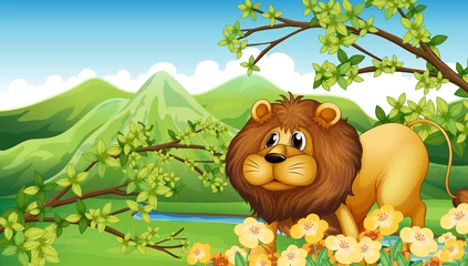 Gordijnen Een leeuw in een groen berggebied © GraphicsRF