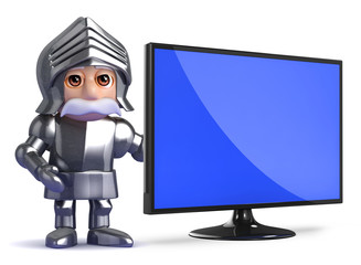 Knight stands by a widescreen monitor