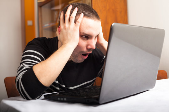 Shocked man with laptop