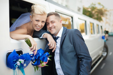 couple in love bride and groom posing at car window