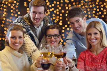 Group of happy young people drink wine at party