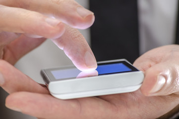 Detail of a finger touching a phone screen