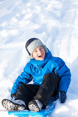 Fototapeta na wymiar young boy with sled