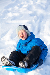 young boy with sled