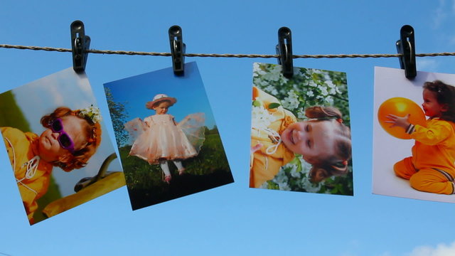 photos are hanging against blue sky