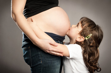 kissing her pregnant mother