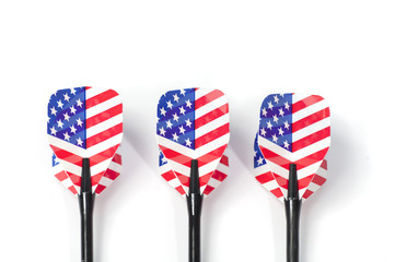 Three target playing darts, whit USA flag colors in the feather