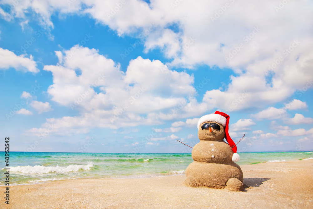 Wall mural Sand snowman in santa hat. Holiday concept can be used for New Y