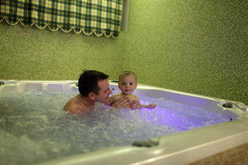 Father with son in jacuzzi