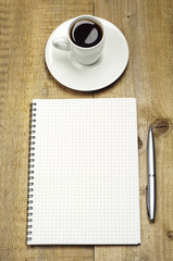 Obraz na płótnie Canvas Notepad, pen and cup of coffee