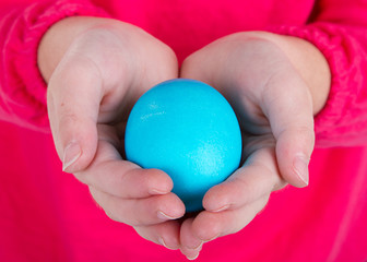 Close up of a child holding an easter egg