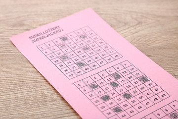 Lottery ticket, on wooden background