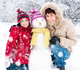 Happy family with snowman