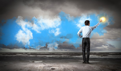 Man standing with back touching sun