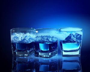 Three glasses of blue liquid