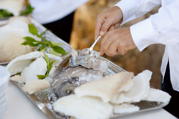 Waiter serving a tasty fish