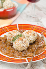 Chicken meatballs in onion sauce closeup