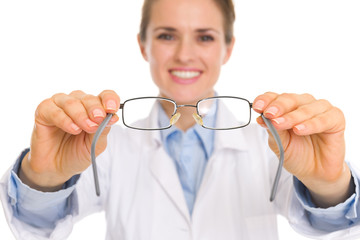 Closeup on medical doctor woman giving eye glasses