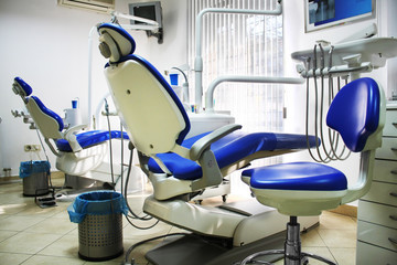 Dental office with two blue and white chairs