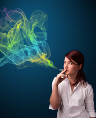 Obraz premium Pretty lady smoking cigarette with colorful smoke
