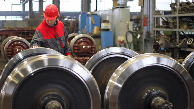 Worker controls wheels of rail vehicles in Factory