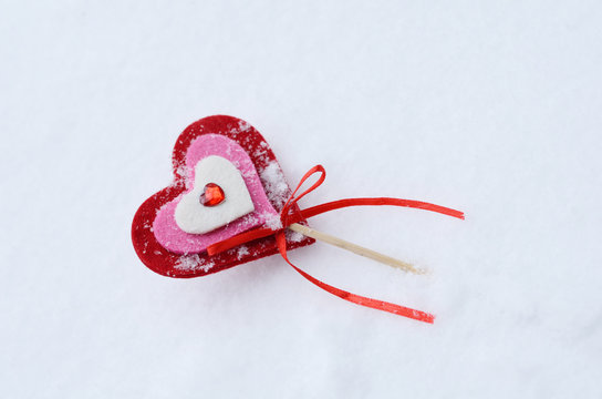 Red decorative heart in the snow
