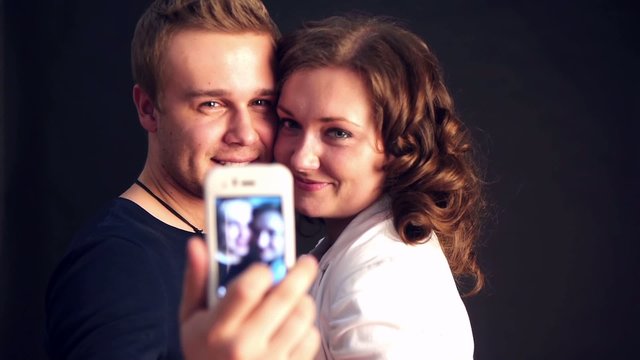 young couple making photo and smiling
