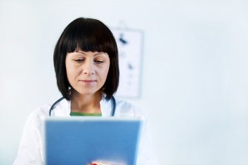 Female doctor holding tablet