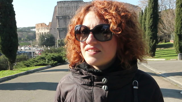 Walking happy woman in autumn colosseum park